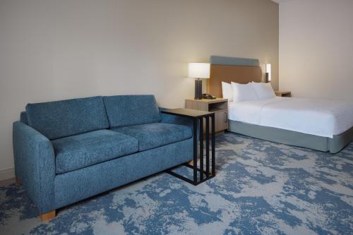 a living room with a couch and a bed at Hampton Inn & Suites Jekyll Island in Jekyll Island