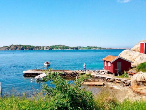 a man standing on a dock on a body of water at 8 person holiday home in ELLÖS in Ellos