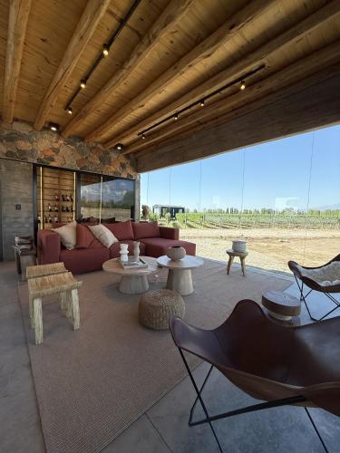 a living room with a couch and chairs and tables at Finca Boutique Un Buen Año in Tres Esquinas