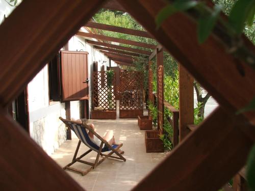 a person sitting in a chair on a patio at Agriturismo Fara del Falco in Vieste