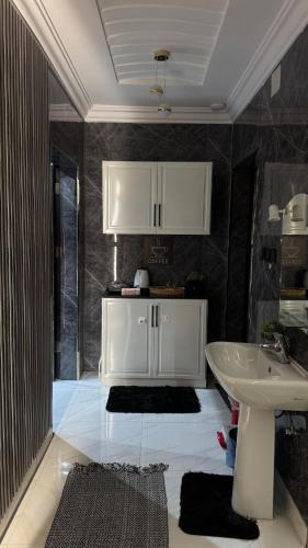 une salle de bain avec un lavabo, des toilettes et un miroir dans l'établissement شقه انيقة بغرفه وصاله مدخل خاص, à ‘Aryam