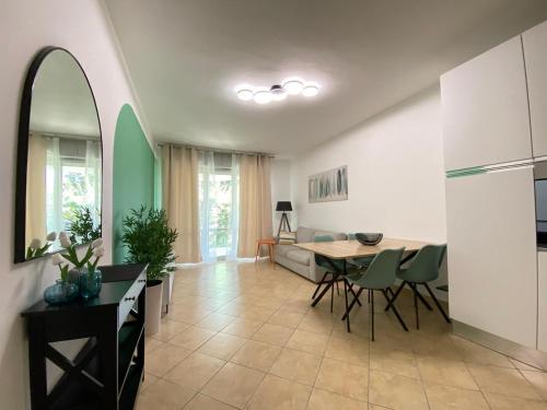 a kitchen and living room with a table and chairs at Lake-Vibes Residence Le Magnolie in Ispra