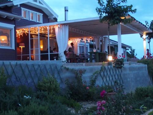 a house with a porch with christmas lights on it at Ktima Noosfera Wellness & Retreat Center in Nees Vrisoules