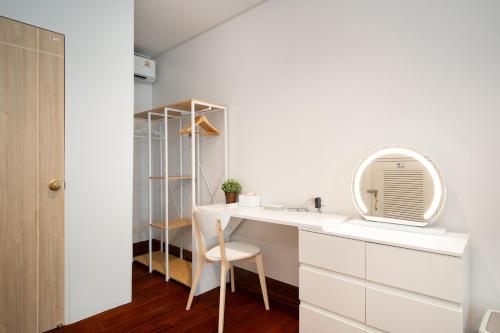 a white bathroom with a sink and a mirror at 2BR 1BA Home In Yaowarat 5 Min MRT Nivas Wanit ECO in Bangkok
