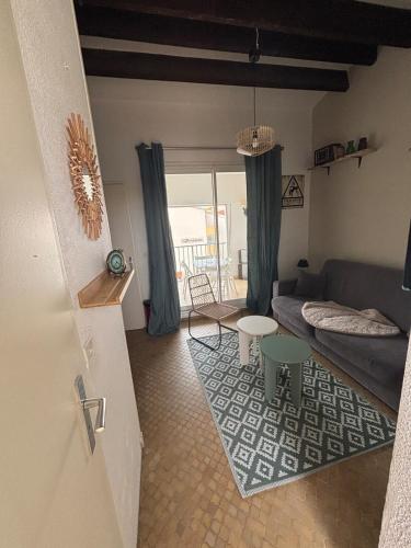 un salon avec un canapé et une table dans l'établissement 150m plage de la conque et commerces appartement 4p, au Cap d'Agde