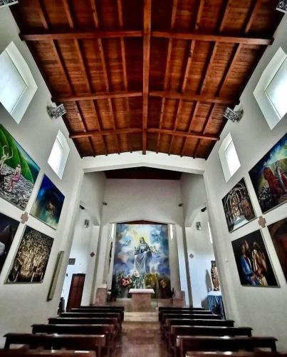 a church with a bunch of paintings on the walls at Locazione Turistica al Castello di Scopoli, situata tra Pale e Rasiglia sulla via Francigena a due passi da Sellano Foligno Assisi e Spoleto in Scopoli