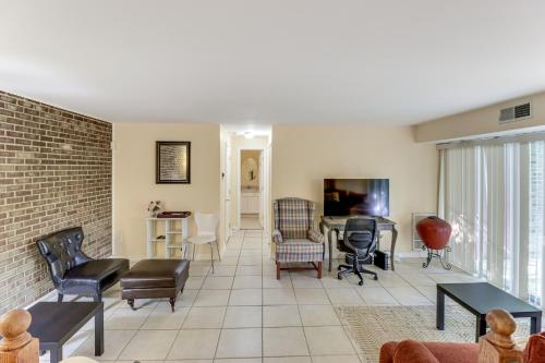 a living room with a couch and a table at 1 Mi to UMD Convenient and Cozy Condo with Patio! in Berwyn Heights