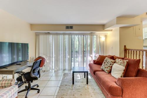 a living room with a couch and a desk at 1 Mi to UMD Convenient and Cozy Condo with Patio! in Berwyn Heights