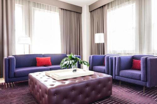 a living room with two blue couches and a coffee table at 21c Museum Hotel Lexington in Lexington