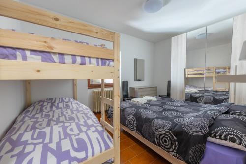 a bedroom with two bunk beds at Appartamento nel Cuore dI Barzio in Barzio