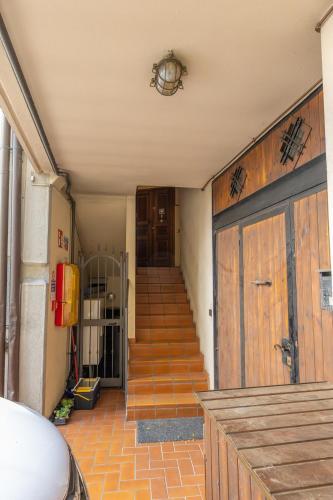 a hallway with a staircase and a door with a door at Appartamento nel Cuore dI Barzio in Barzio