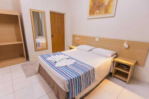 Postel nebo postele na pokoji v ubytování Hotel Dan Inn Barretos by Nacional Inn