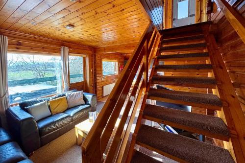 a staircase leading to a living room in a cabin at Tor View Lodge with Hot Tub & Sauna - Spa Resort - South Devon in Chudleigh Knighton