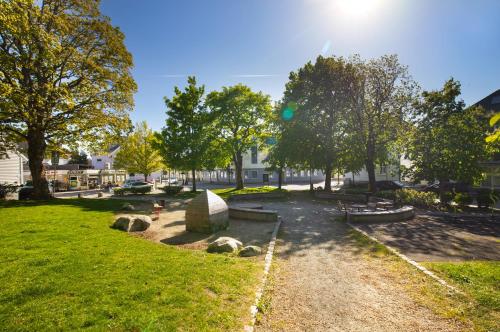 a park with benches and trees on a sunny day at Central Guest House - Bedroom with Private Bathroom in Stavanger