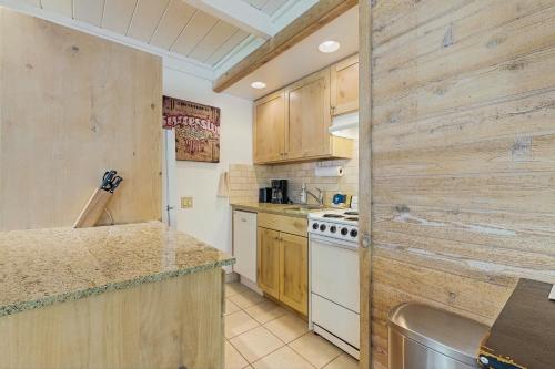 a kitchen with wooden cabinets and a white stove top oven at 1069 Atelier in Sun Valley