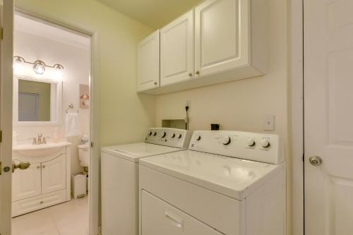 a white laundry room with a washer and dryer at Calming Getaway 9 Mi to Clearwater Beach! in Clearwater