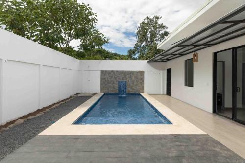 a swimming pool in the backyard of a house at Casa Aurora With Private Patio & Pool in Coco