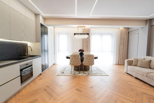 a kitchen and living room with a table and chairs at Maison Apartment - NEO TOWER in Suceava