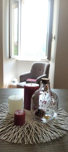 a glass vase sitting on a table with candles at Casa Milla in Tremezzo