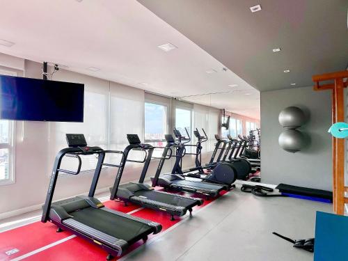 una palestra con un mucchio di tapis roulant in una stanza di Refúgio Privado Liberdade: A/C + Rooftop ao lado do metro a San Paolo