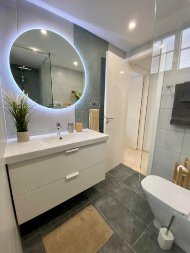 a bathroom with a sink and a mirror at Angelina retreat close to beach in Pyla