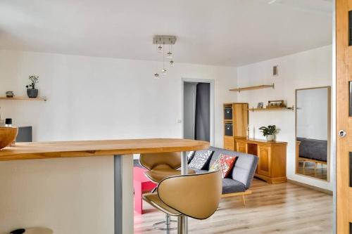 une cuisine et un salon avec une table et des chaises dans l'établissement Bel appartement St Michel, à Toulouse
