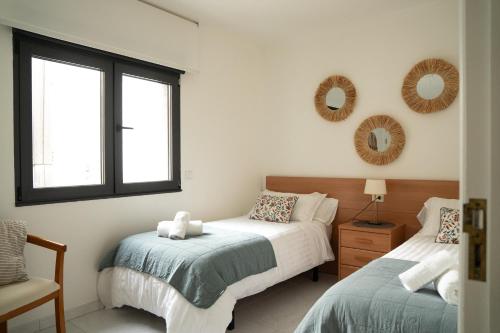 Posteľ alebo postele v izbe v ubytovaní Apartamento Faro da Rocha