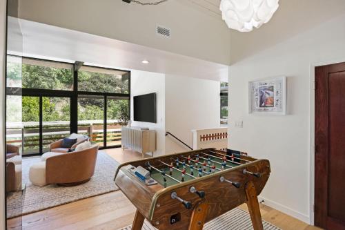 a living room with a foosball table at New Listing Architectural Villa by Colby & Conrad in Los Angeles