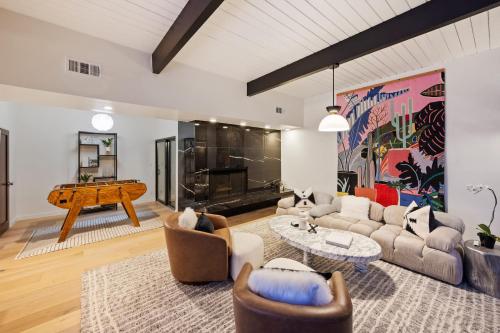 a living room with a couch and a piano at New Listing Architectural Villa by Colby & Conrad in Los Angeles