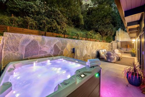 a jacuzzi tub in a backyard with a patio at New Listing Architectural Villa by Colby & Conrad in Los Angeles