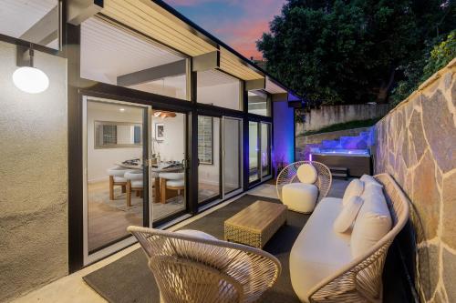 a patio with a table and chairs and a dining room at New Listing Architectural Villa by Colby & Conrad in Los Angeles
