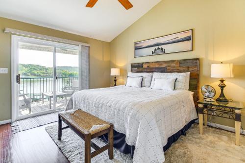 a bedroom with a large bed and a balcony at On-Site Lake of the Ozarks Access Camdenton Condo in Camdenton