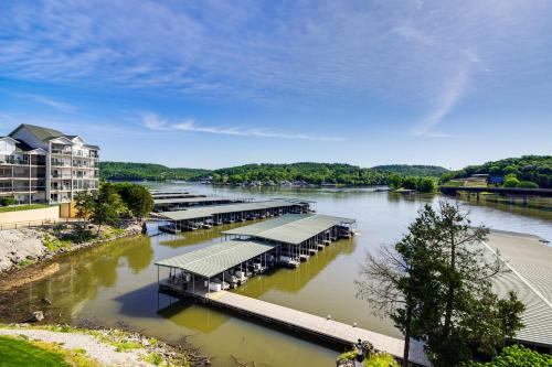 a river with a bunch of docks on the water at On-Site Lake of the Ozarks Access Camdenton Condo in Camdenton