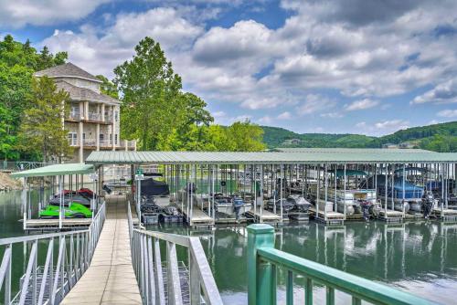 a marina with boats on the water and a building at On-Site Lake of the Ozarks Access Camdenton Condo in Camdenton