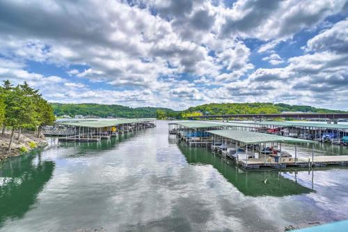 a river with a bunch of docks on the water at On-Site Lake of the Ozarks Access Camdenton Condo in Camdenton