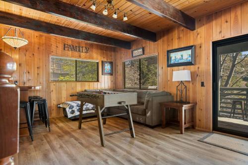 a living room with a ping pong table in it at Pine Oaks Cabin in Lake Arrowhead