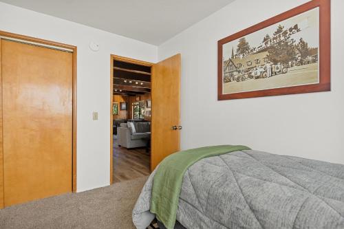 a bedroom with a bed and a picture on the wall at Pine Oaks Cabin in Lake Arrowhead