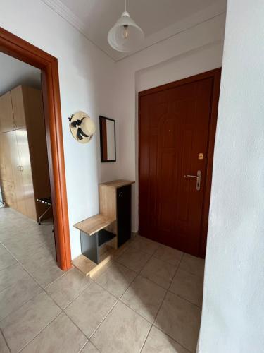 a hallway with a brown door and a tiled floor at Seaside Apartment in Vergia Chalkidiki in Vergia
