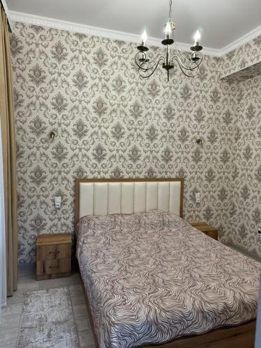 a bedroom with a bed and a chandelier at Issyk-Kul, Sary-Oi, Atlantis in Chetkoysu