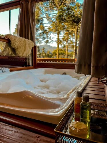 a large mattress sitting on a table with a window at Pousada Vale da Neve in Urubici