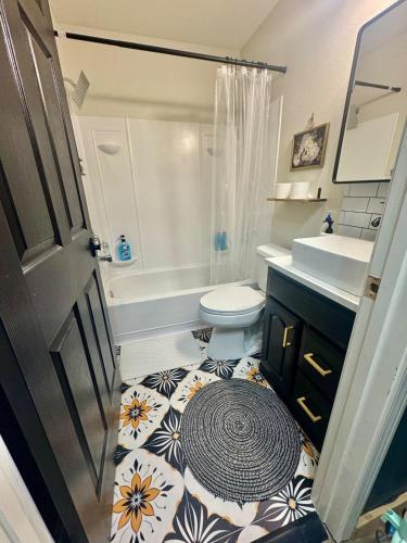 a bathroom with a toilet and a sink at Harbor Hideaway in Port Orchard