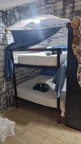 a bunk bed with two mattresses on the bottom bunk at War Bunker Hostel in Sarandë