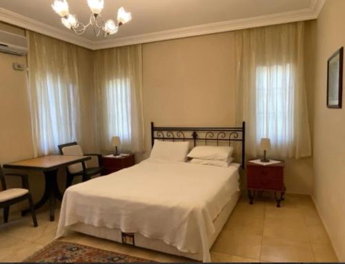 a bedroom with a bed and a table and chairs at Villa Caretta Luna in Ortaca