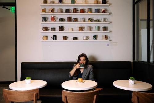 a woman sitting at a table taking a picture at Marriott Knoxville Downtown in Knoxville