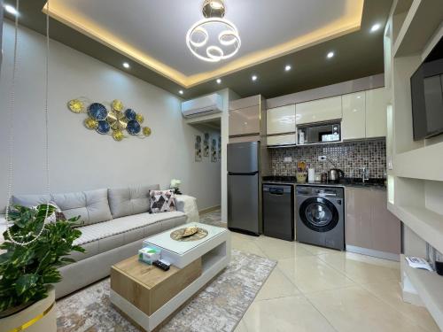 a living room with a couch and a kitchen at Sharm Hills Luxury Studio with pool view in Sharm El Sheikh