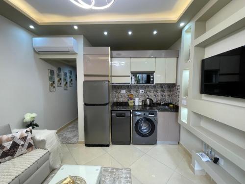 a kitchen with a washer and dryer in a room at Sharm Hills Luxury Studio with pool view in Sharm El Sheikh