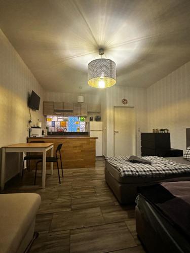 a room with a bed and a table and a kitchen at Studio in Berlin9 in Berlin