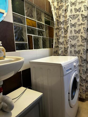 a bathroom with a washing machine and a sink at Studio in Berlin9 in Berlin