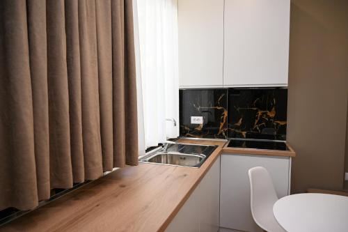 a small kitchen with a sink and a window at Swiss Lux apartments in Durrës