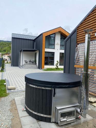 a house with a tv in front of it at The NEST Villa in Borşa